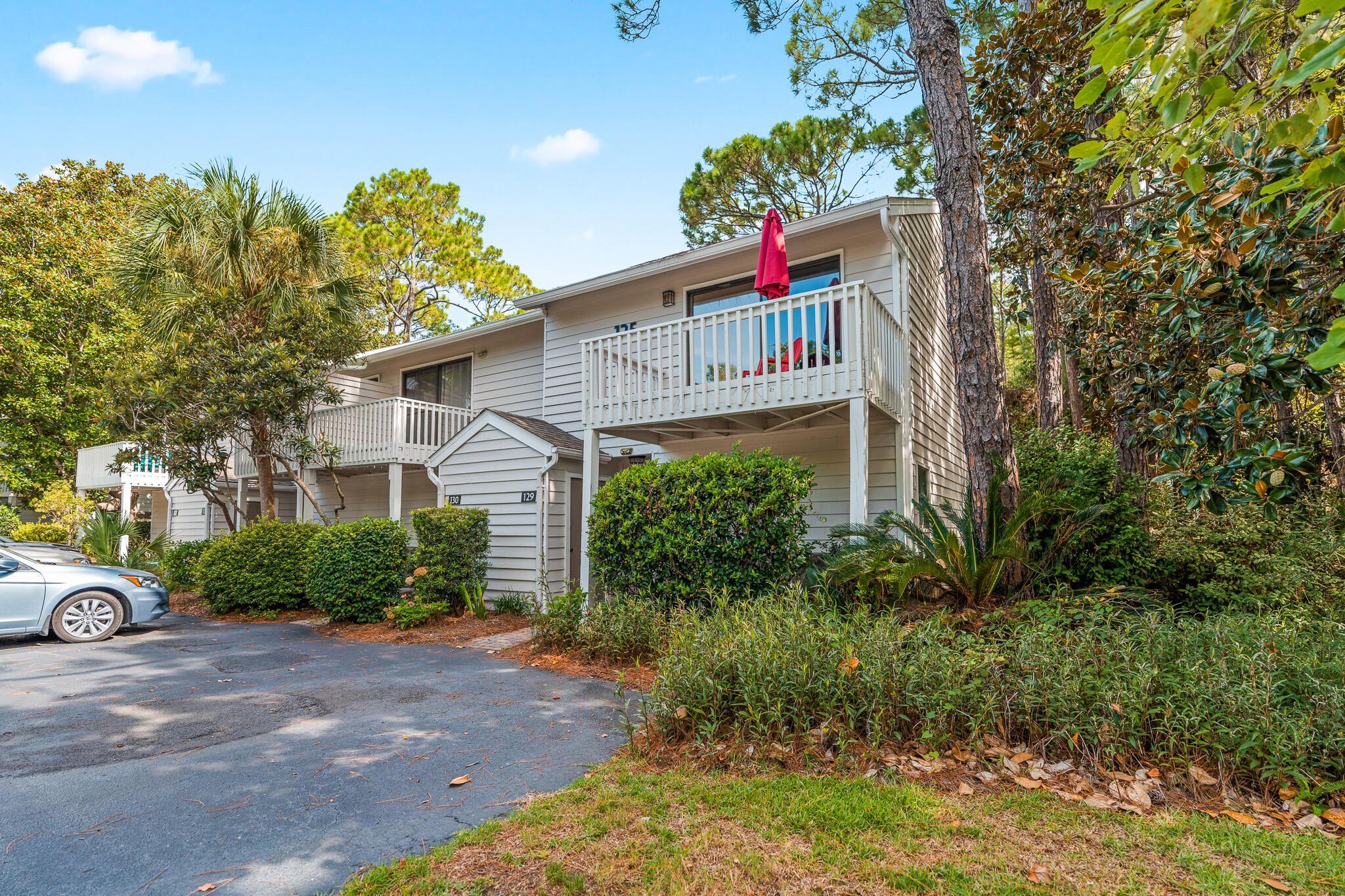 125 Cassine Garden Circle, Unit 129 Santa Rosa Beach, FL 32459 - Photo 53 of 70 a front view of a house with a yard and garage