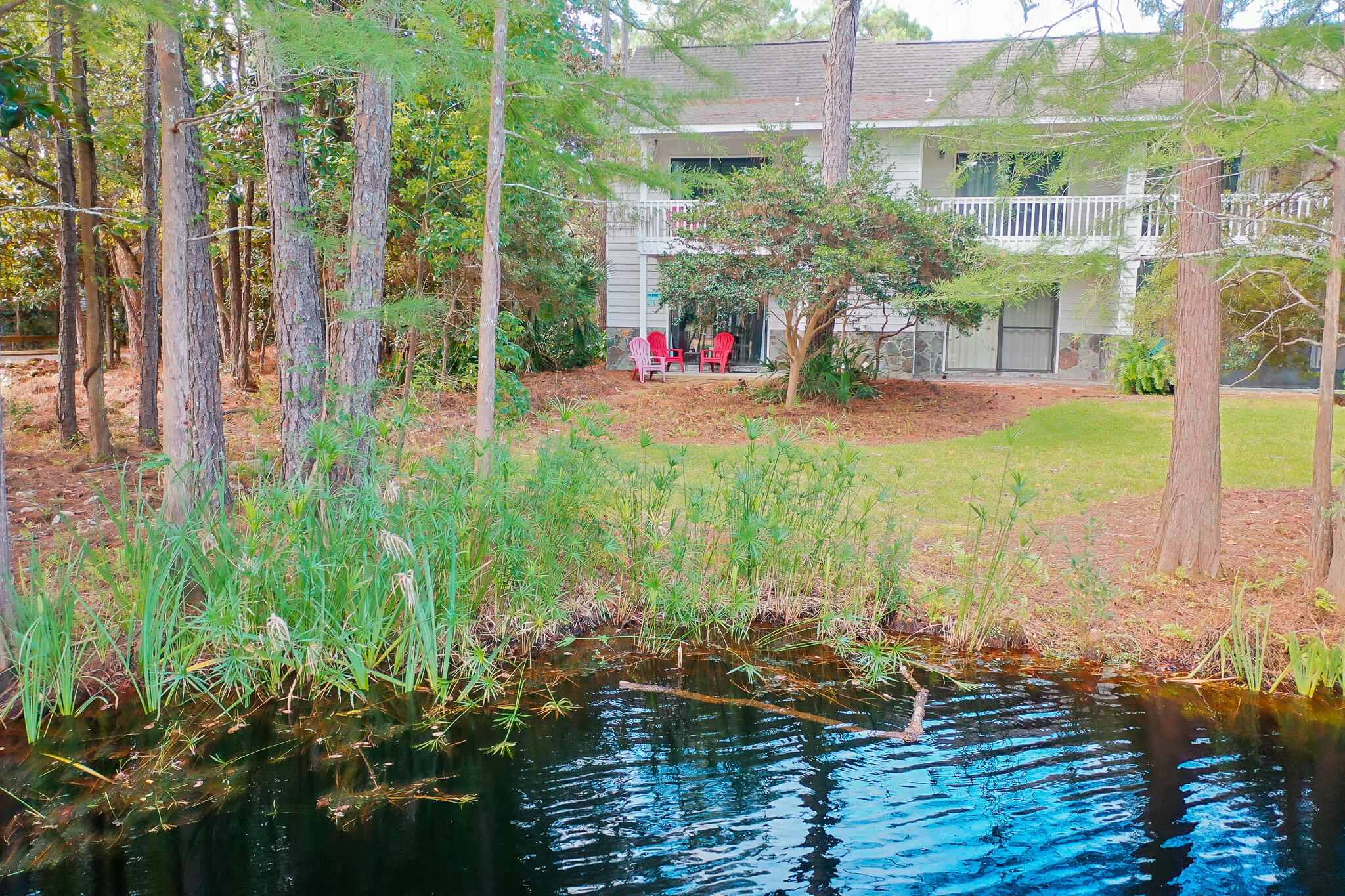 125 Cassine Garden Circle, Unit 129 Santa Rosa Beach, FL 32459 - Photo 66 of 70 a view of swimming pool with lawn chairs and floor to ceiling window