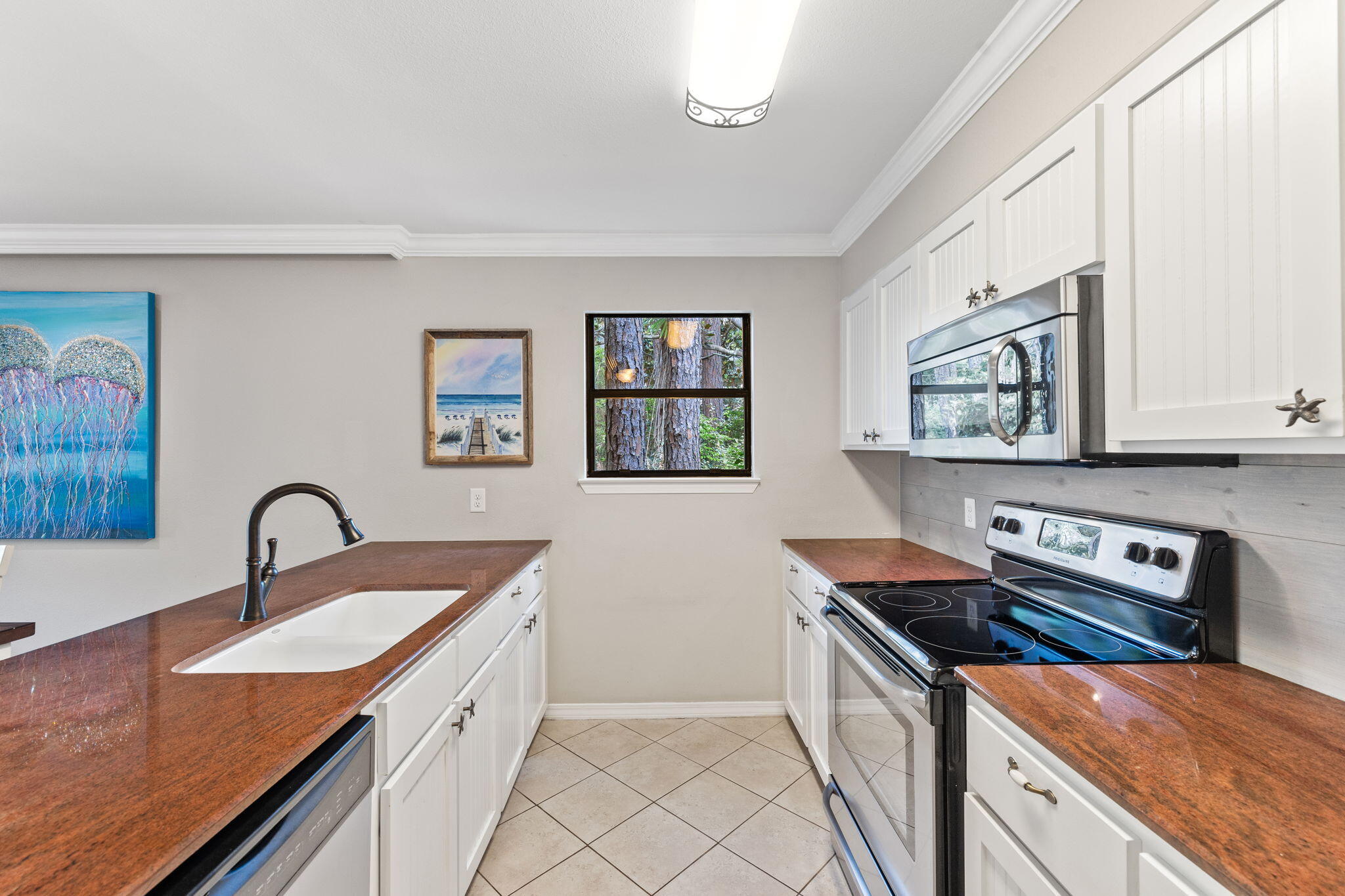 125 Cassine Garden Circle, Unit 129 Santa Rosa Beach, FL 32459 - Photo 9 of 70 a kitchen with stainless steel appliances granite countertop a sink stove and cabinets