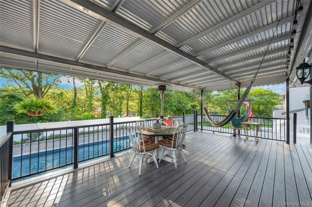 a view of a deck with wooden floor and outdoor seating