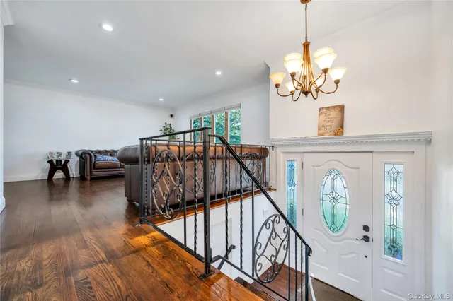 a view of a livingroom with furniture staircase and hallway