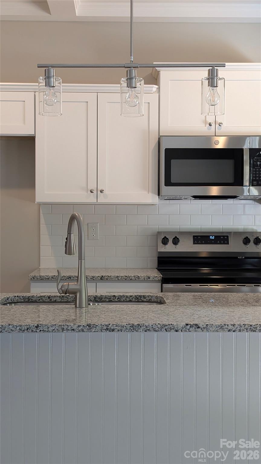 3339 Lesslie Highway, Unit 2 Rock Hill, SC 29730 - Photo 41 of 46 a kitchen with stainless steel appliances granite countertop a sink a stove and a microwave
