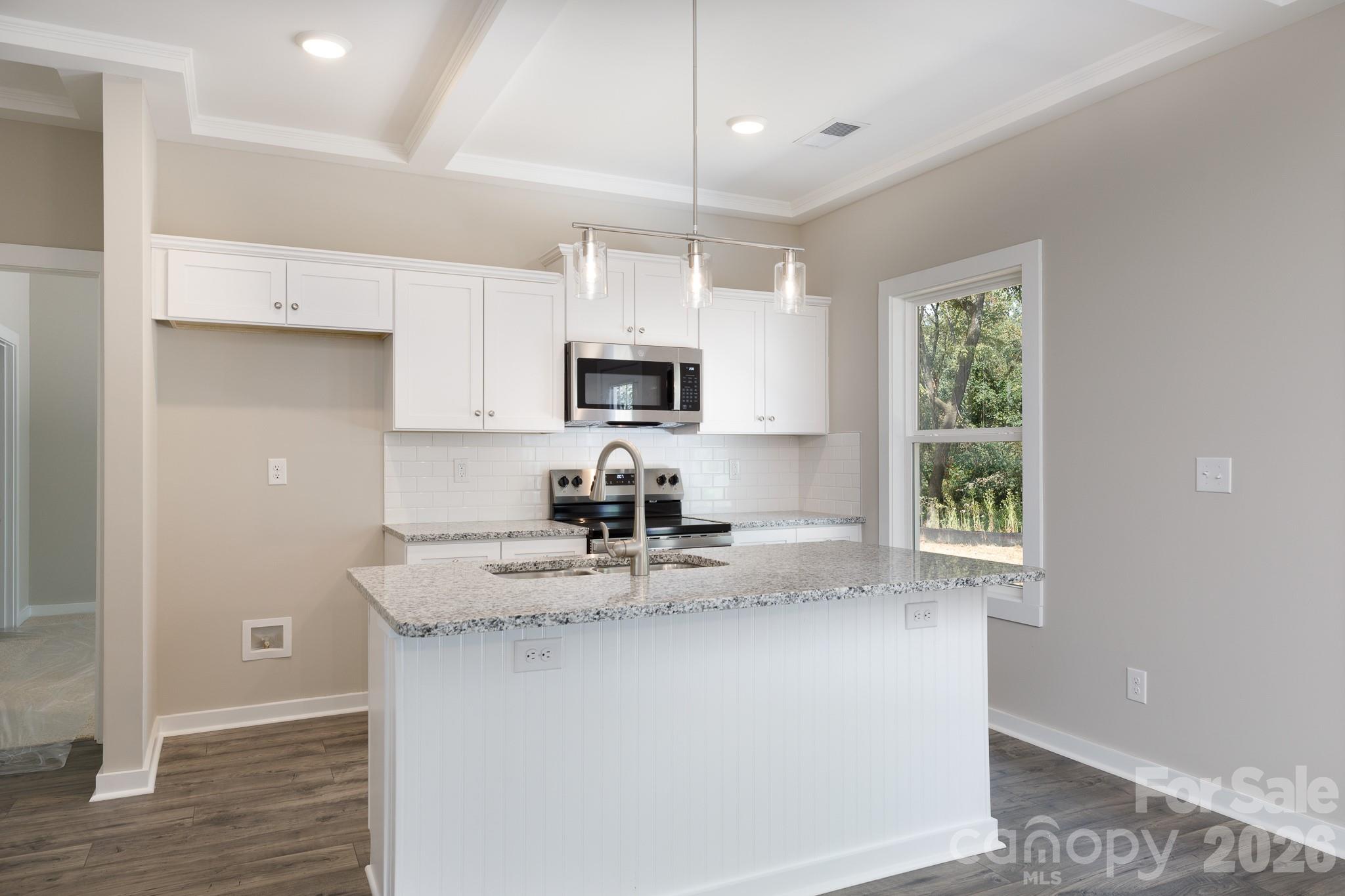3339 Lesslie Highway, Unit 2 Rock Hill, SC 29730 - Photo 8 of 46 a kitchen with kitchen island granite countertop a sink window and cabinets
