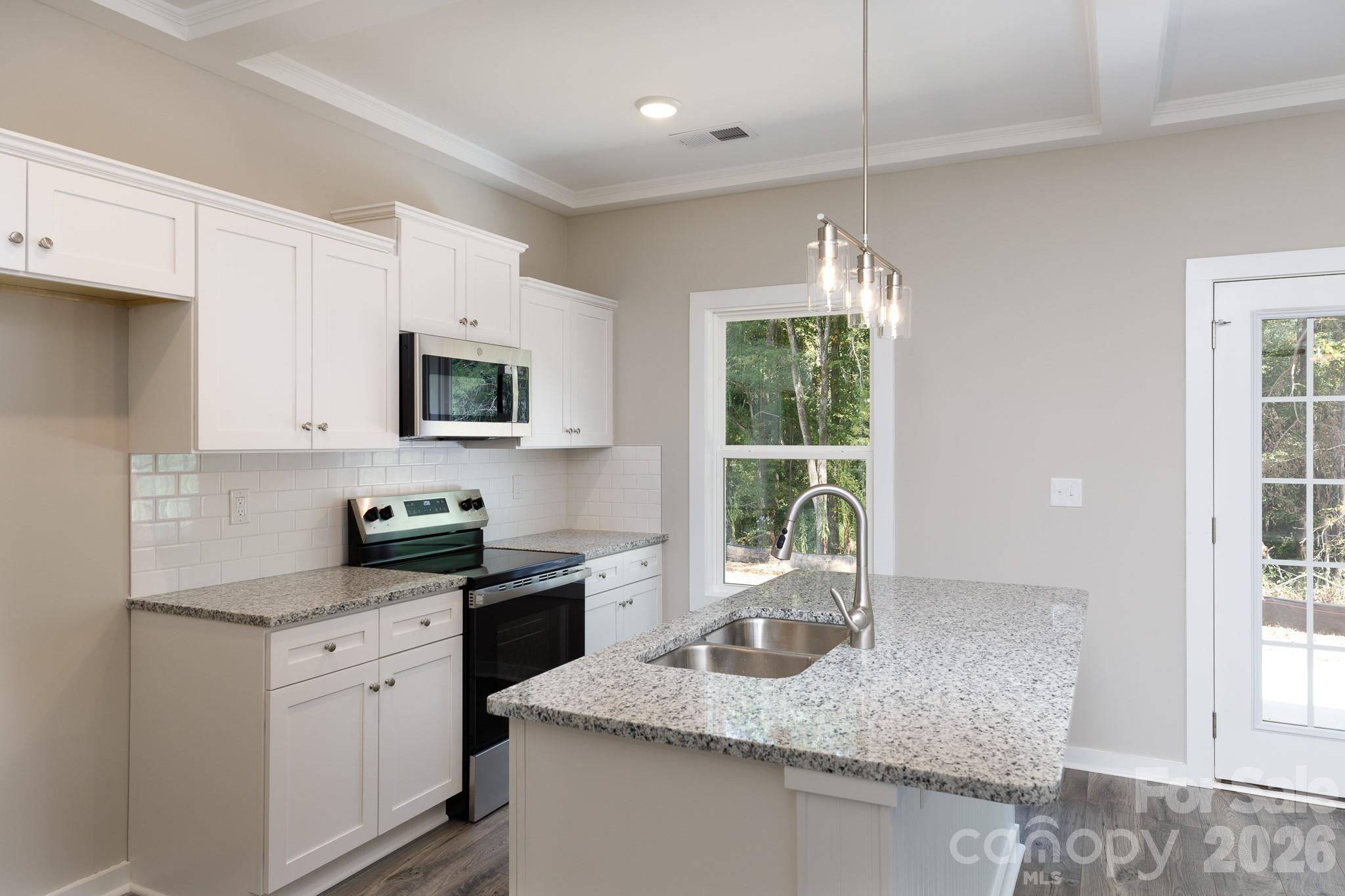 3339 Lesslie Highway, Unit 2 Rock Hill, SC 29730 - Photo 9 of 46 a kitchen with granite countertop a sink white cabinets and a window