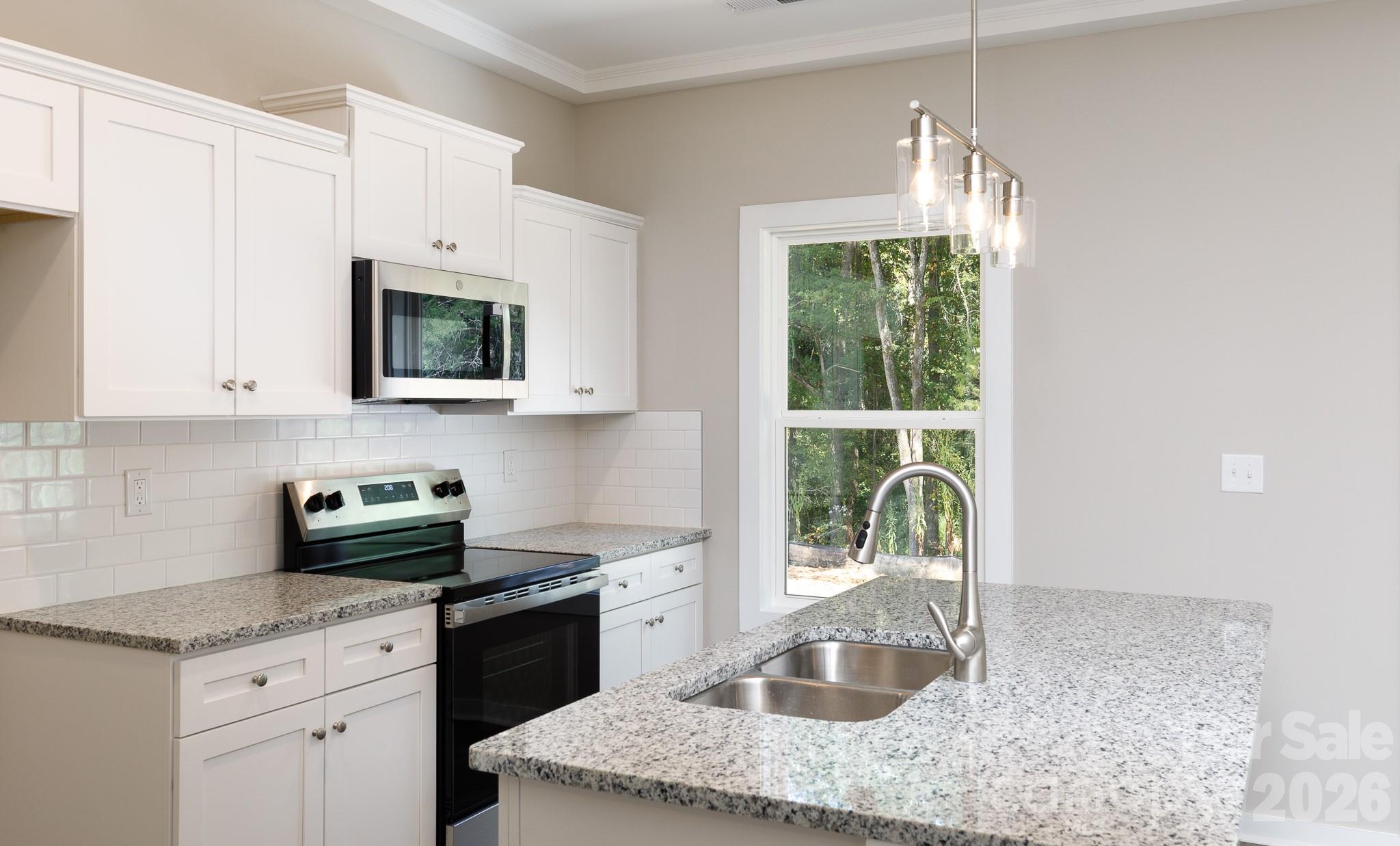 3339 Lesslie Highway, Unit 2 Rock Hill, SC 29730 - Photo 10 of 46 a kitchen with granite countertop a sink a window and stainless steel appliances