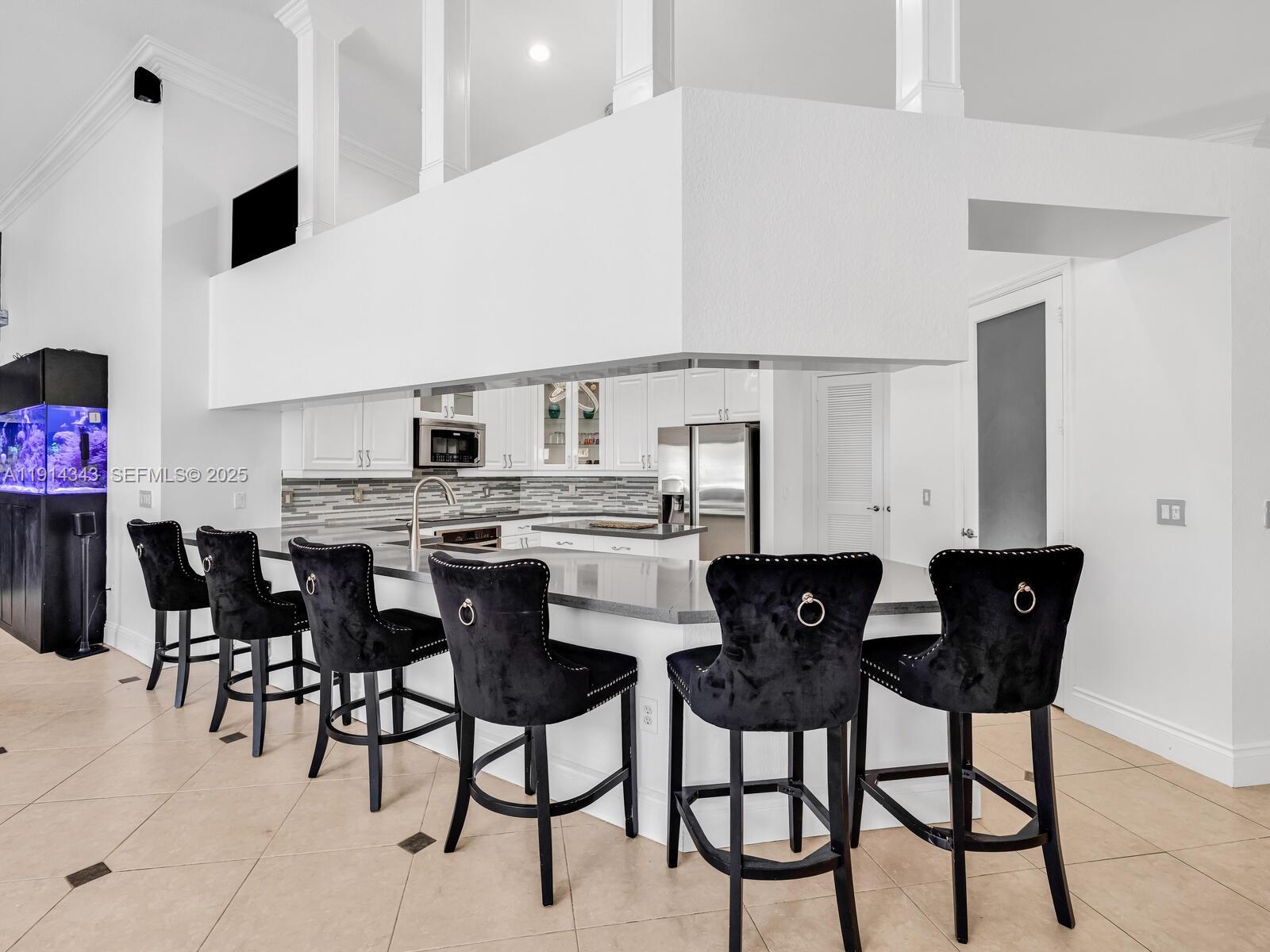 12995 Southwest 40 Street Davie, FL 33330 - Photo 13 of 79 a view of a dining room with furniture and wooden floor