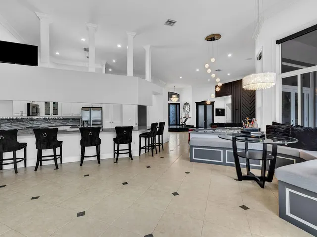 a view of a dining room with furniture and chandelier