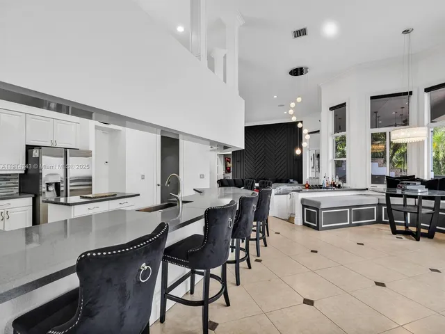a living room with furniture and a dining table with kitchen view