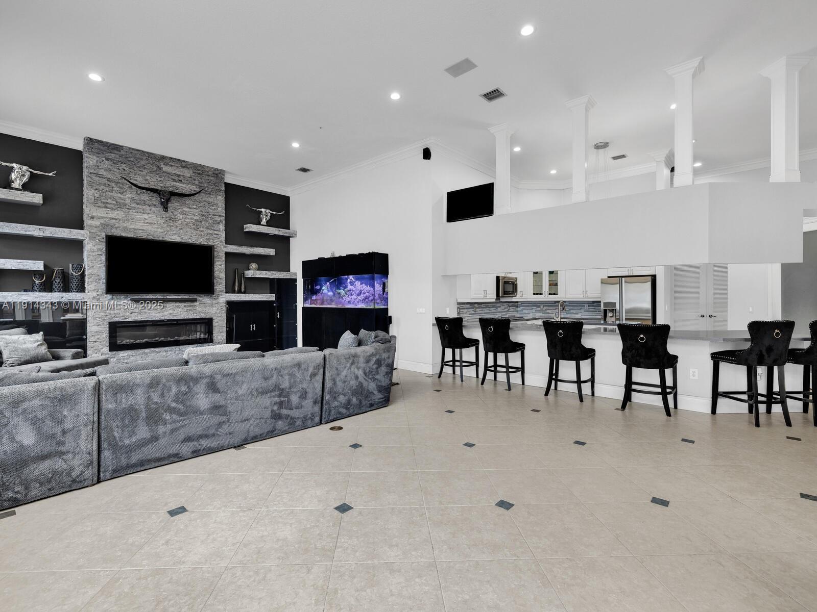 12995 Southwest 40 Street Davie, FL 33330 - Photo 17 of 79 a living room with furniture and a flat screen tv