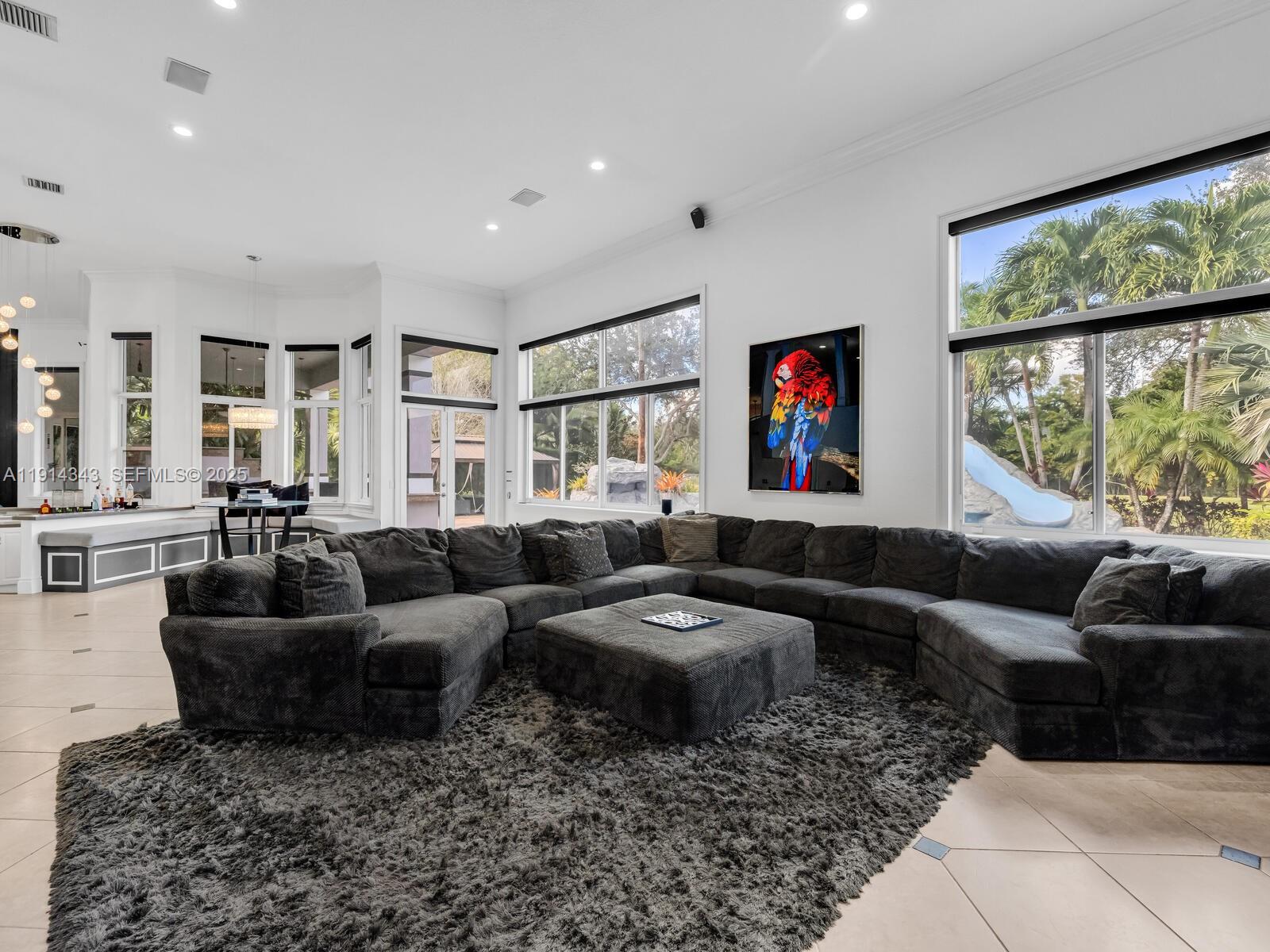 12995 Southwest 40 Street Davie, FL 33330 - Photo 27 of 79 a living room with furniture and a large window