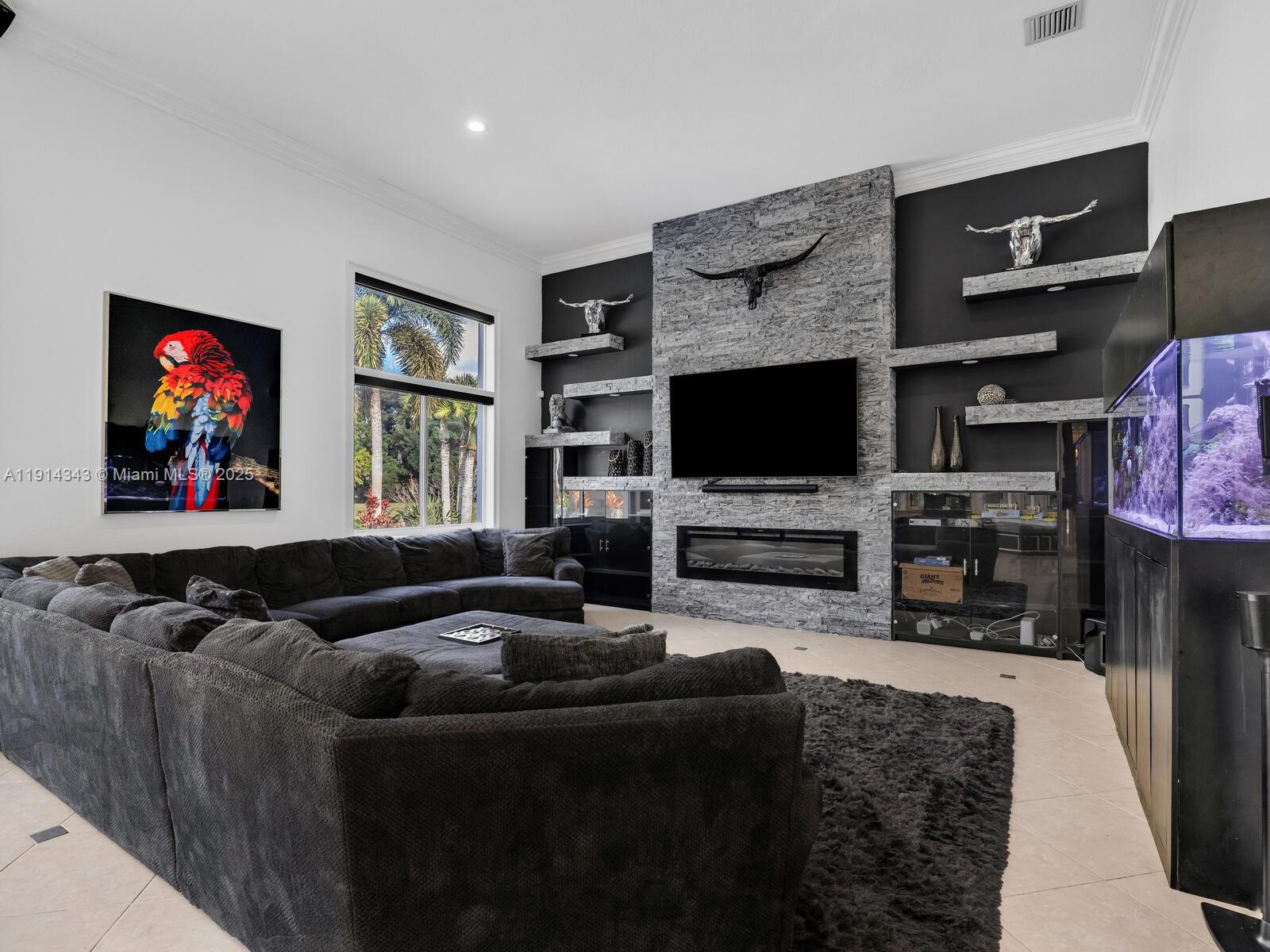 12995 Southwest 40 Street Davie, FL 33330 - Photo 28 of 79 a living room with furniture and a flat screen tv