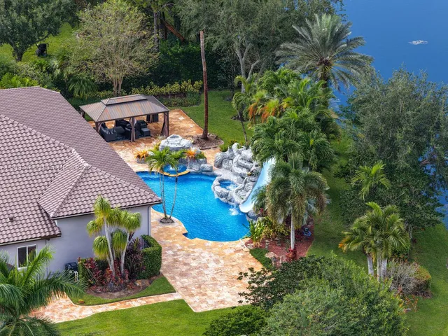 an aerial view of a house with garden space and street view