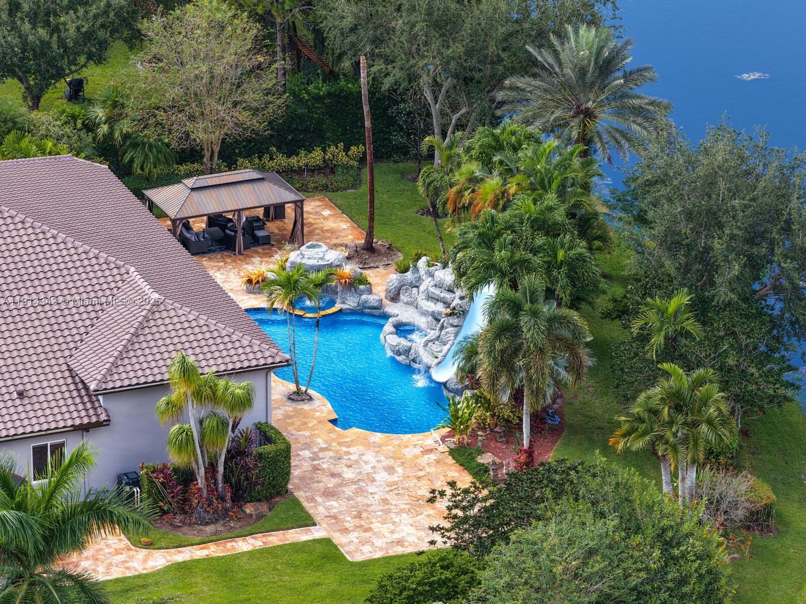 12995 Southwest 40 Street Davie, FL 33330 - Photo 3 of 79 an aerial view of a house with garden space and street view