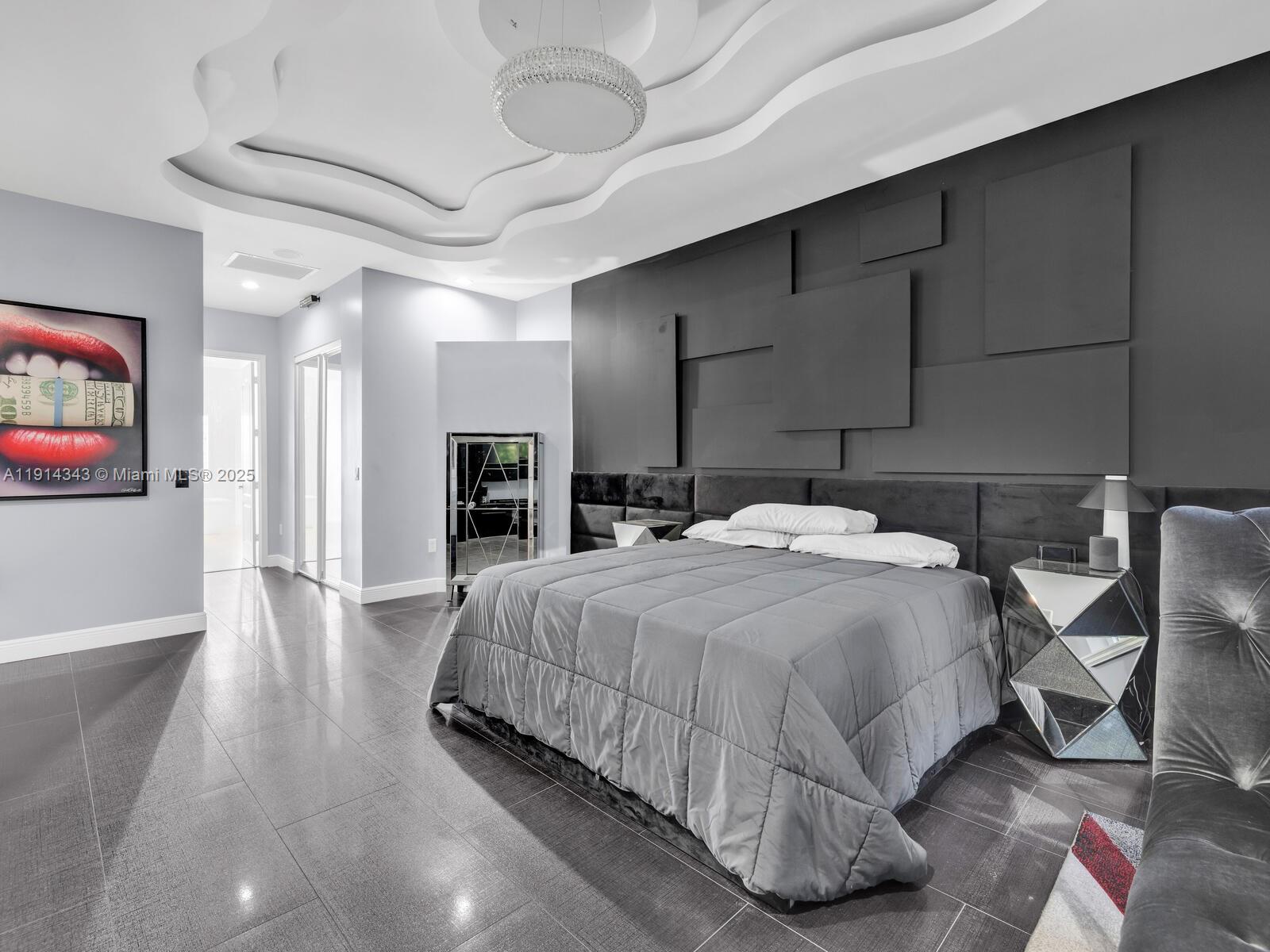 12995 Southwest 40 Street Davie, FL 33330 - Photo 34 of 79 a bedroom with a bed and a flat screen tv