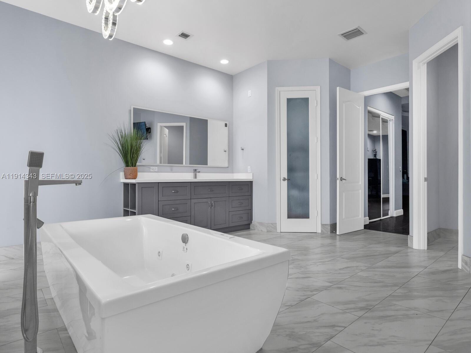 12995 Southwest 40 Street Davie, FL 33330 - Photo 39 of 79 a bathroom with a bathtub and a sink