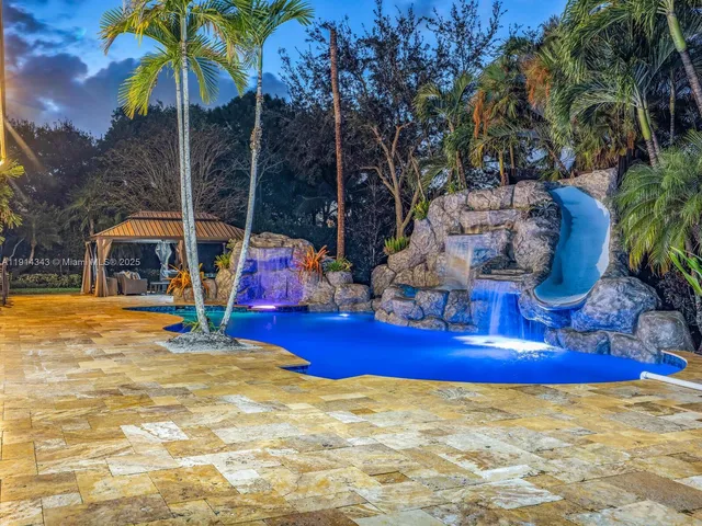 a view of swimming pool with sitting area and slide