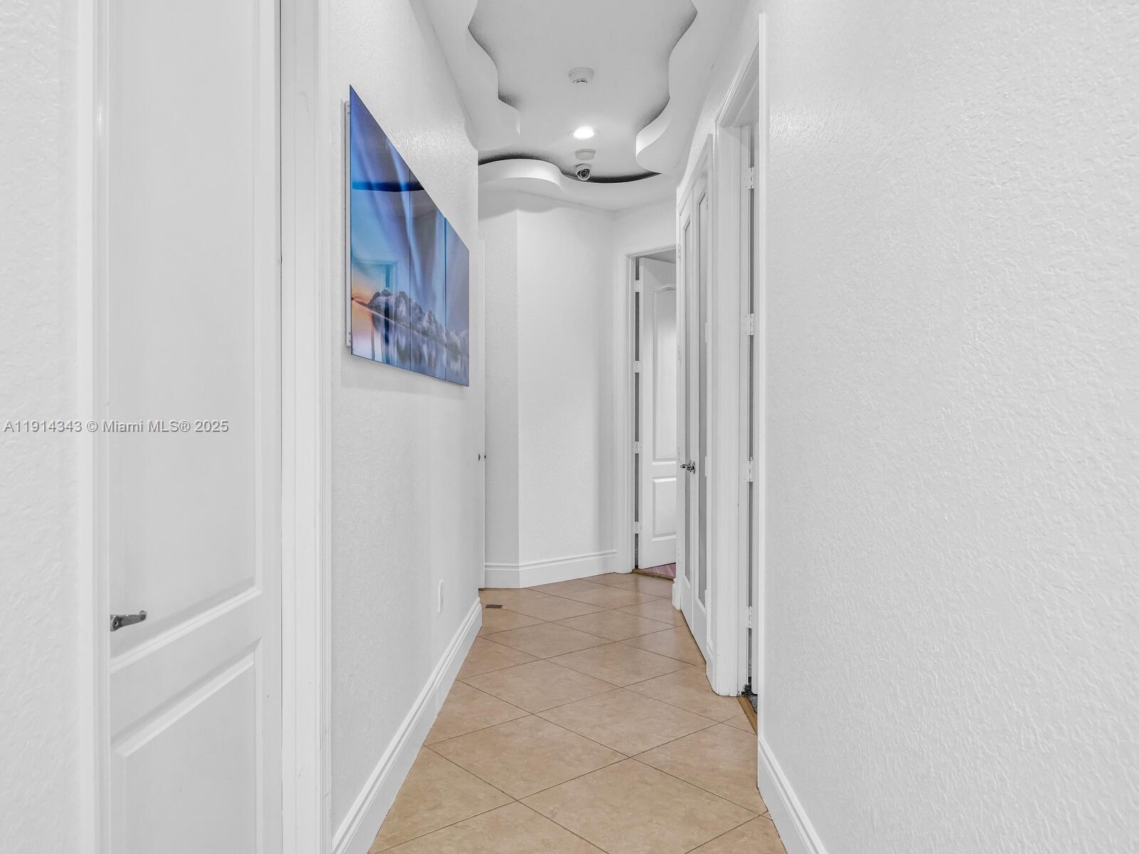 12995 Southwest 40 Street Davie, FL 33330 - Photo 45 of 79 Hallway to the right wing where the secondary bedrooms are situated