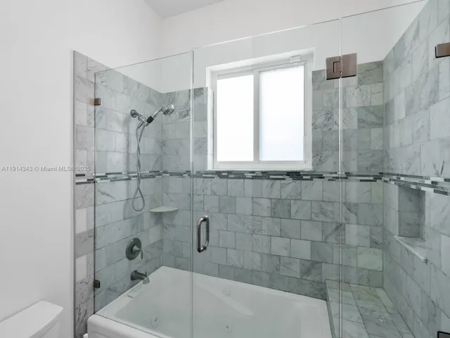 a view of patio with table and chairs and couches with wooden floor and fence