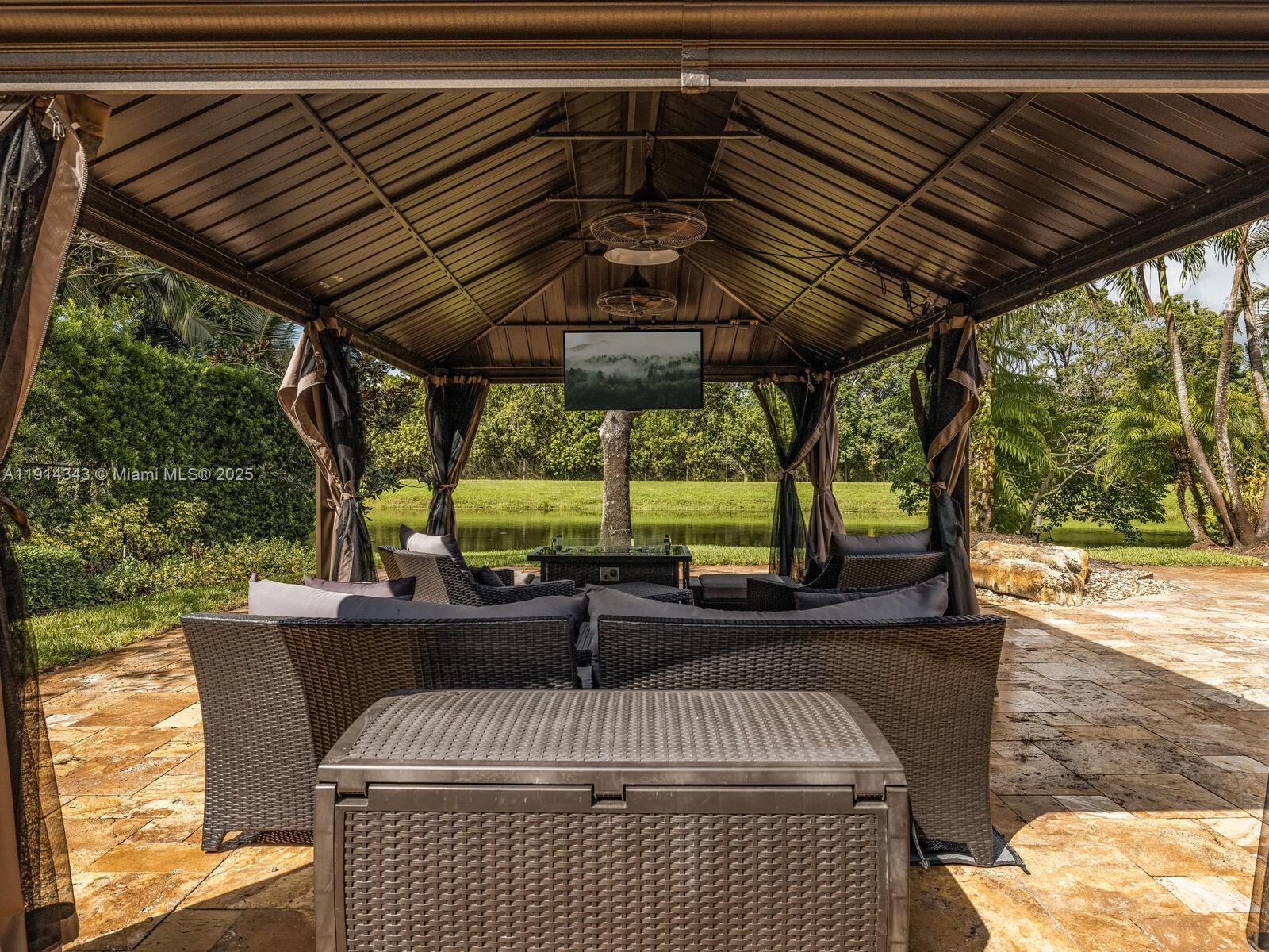 12995 Southwest 40 Street Davie, FL 33330 - Photo 69 of 79 a view of patio with table and chairs and couches with wooden floor and fence