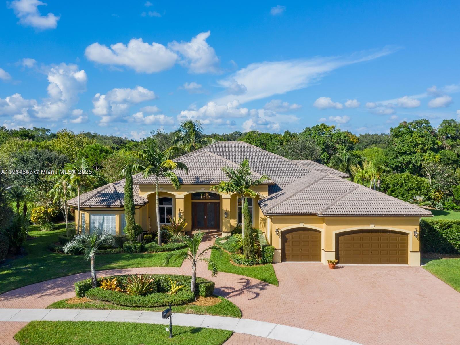 12995 Southwest 40 Street Davie, FL 33330 - Photo 8 of 79 a front view of a house with a yard table and chairs