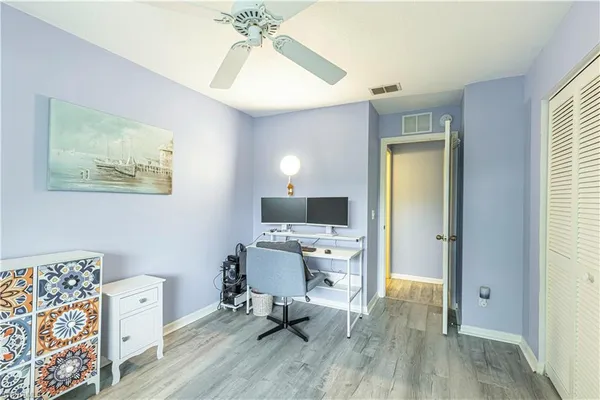 a workspace room with furniture and wooden floor