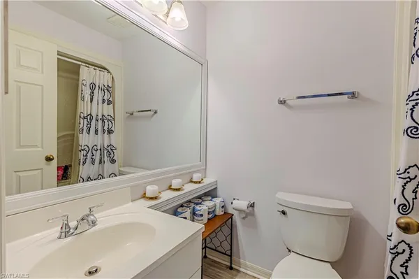 a bathroom with a sink mirror and toilet