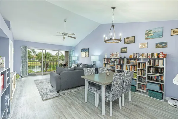 a dining room with furniture a chandelier and wooden floor