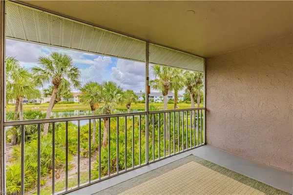 a front view of a house with a yard and potted plants