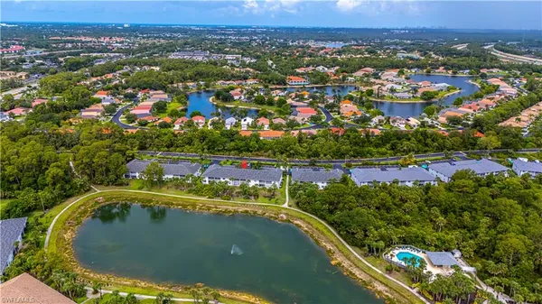 an aerial view of residential houses with outdoor space and swimming pool