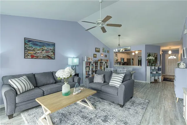 a living room with furniture and wooden floor