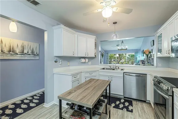 a kitchen with a table chairs stove and cabinets