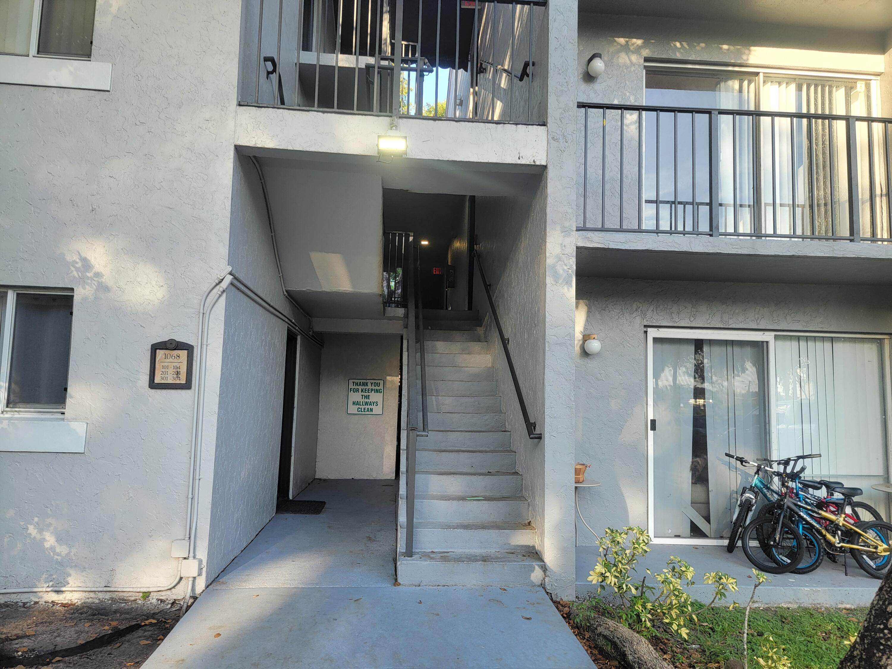 1068 Benoist Farms Road, Unit 204 West Palm Beach, FL 33411 - Photo 3 of 11 a view of entryway and hall with wooden floor