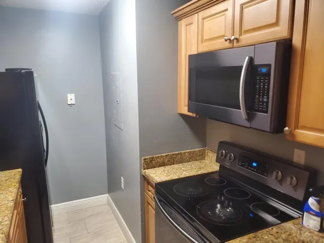 a kitchen with a stove and a microwave