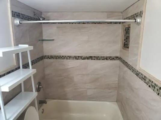 a bathroom with a shower and a tub