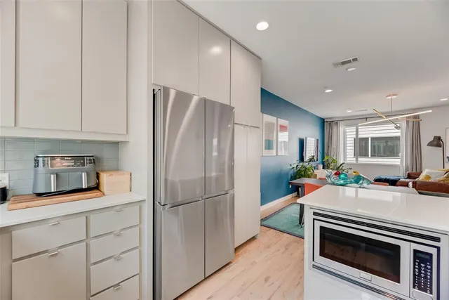 a kitchen with stainless steel appliances a refrigerator sink and cabinets