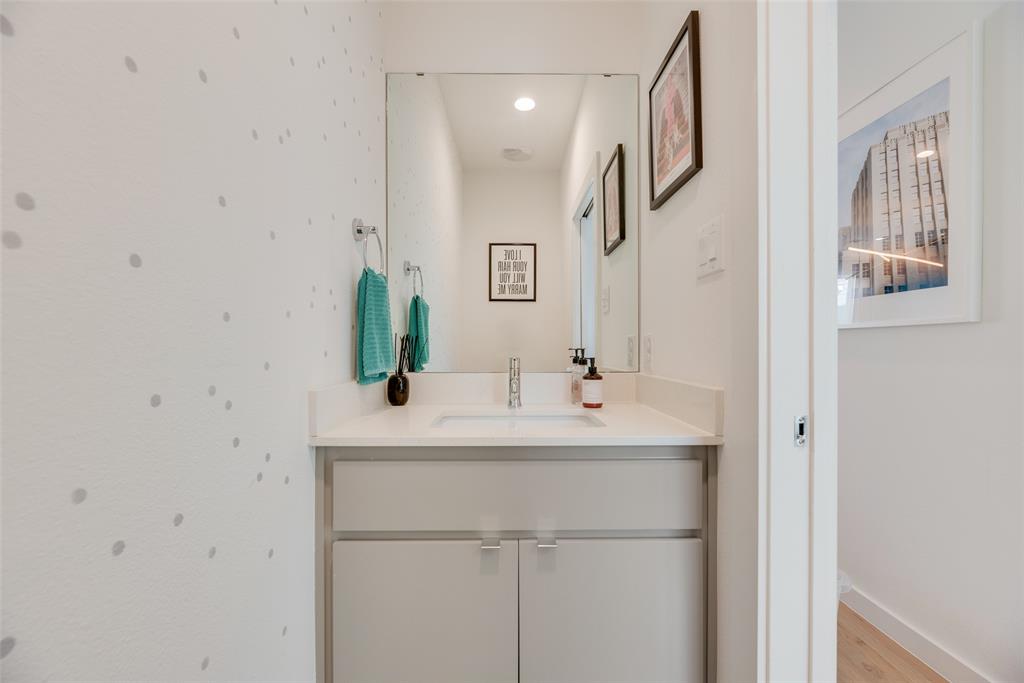 4705 Bryan Street, Unit 302 Dallas, TX 75204 - Photo 18 of 28 a bathroom with a sink and a mirror
