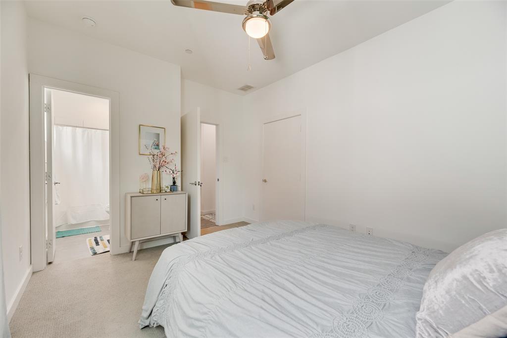 4705 Bryan Street, Unit 302 Dallas, TX 75204 - Photo 21 of 28 a bedroom with a bed and cabinets