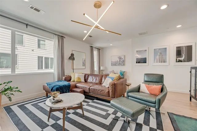 a living room with furniture and wooden floor
