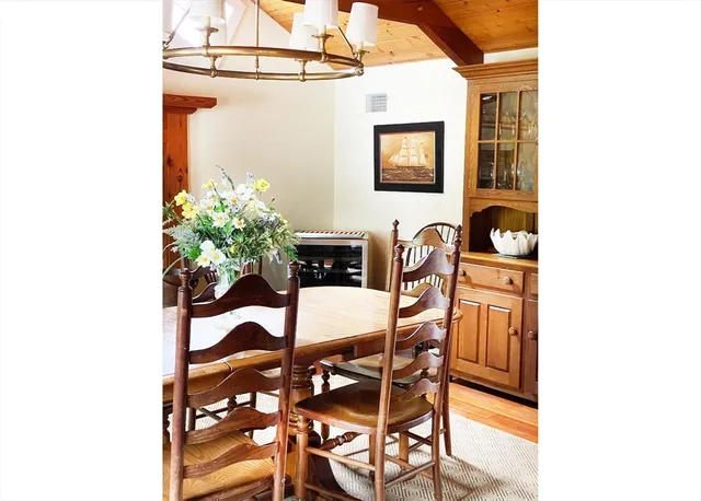 a vase of flowers sitting on a table in front of a door