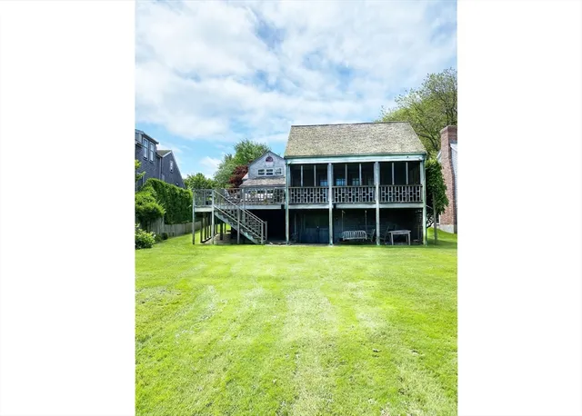 a view of a backyard with table and chairs and potted plants