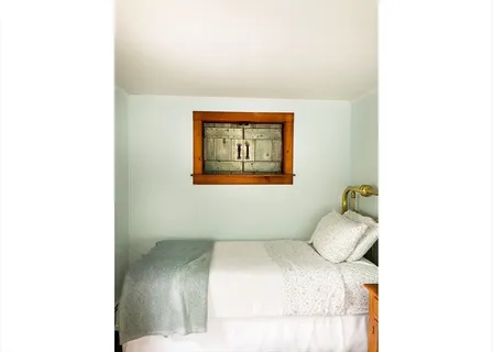 a bathroom with a granite countertop sink a mirror and shower