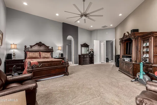 a bedroom with a bed a window and a television