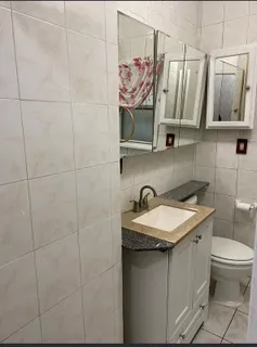 a bathroom with a sink a toilet and mirror