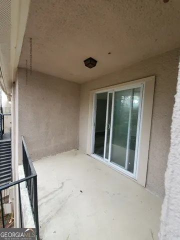 a view of a balcony with furniture