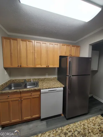 a kitchen with stainless steel appliances granite countertop a stove and a microwave