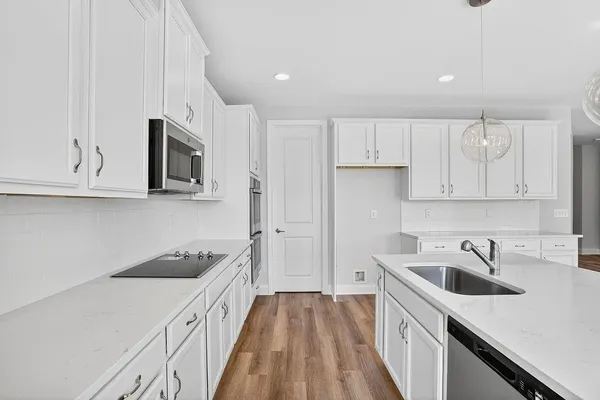 a kitchen with a sink a stove and cabinets