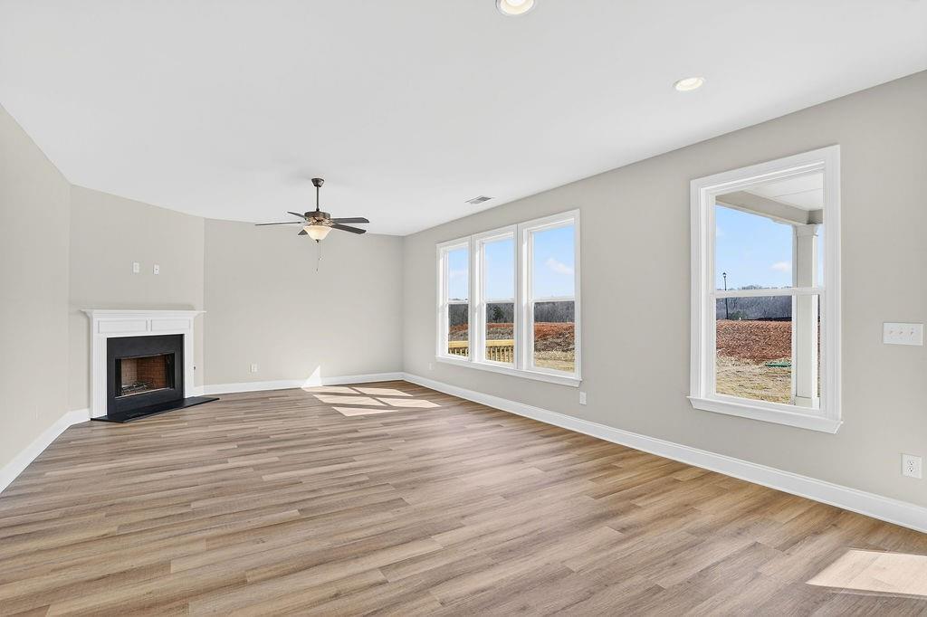 140 Classic Overlook Homer, GA 30547 - Photo 14 of 36 a view of an empty room with wooden floor fireplace and a window