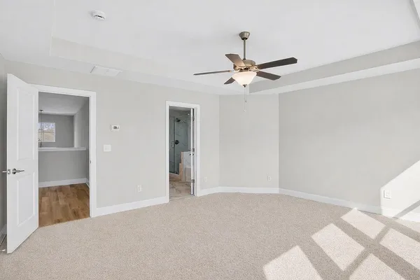 a view of a livingroom with a ceiling fan and entryway