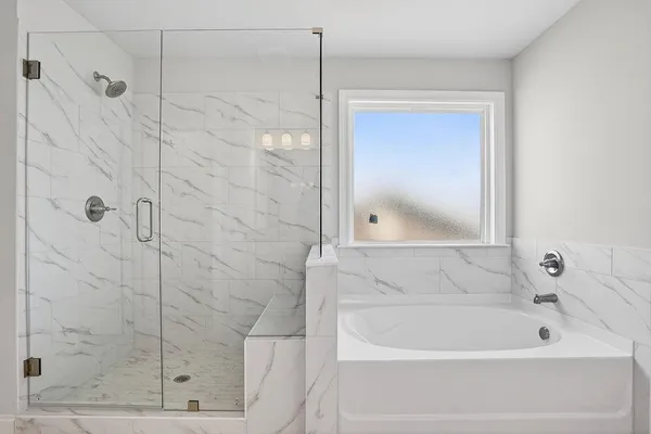 a bathroom with a bathtub and shower