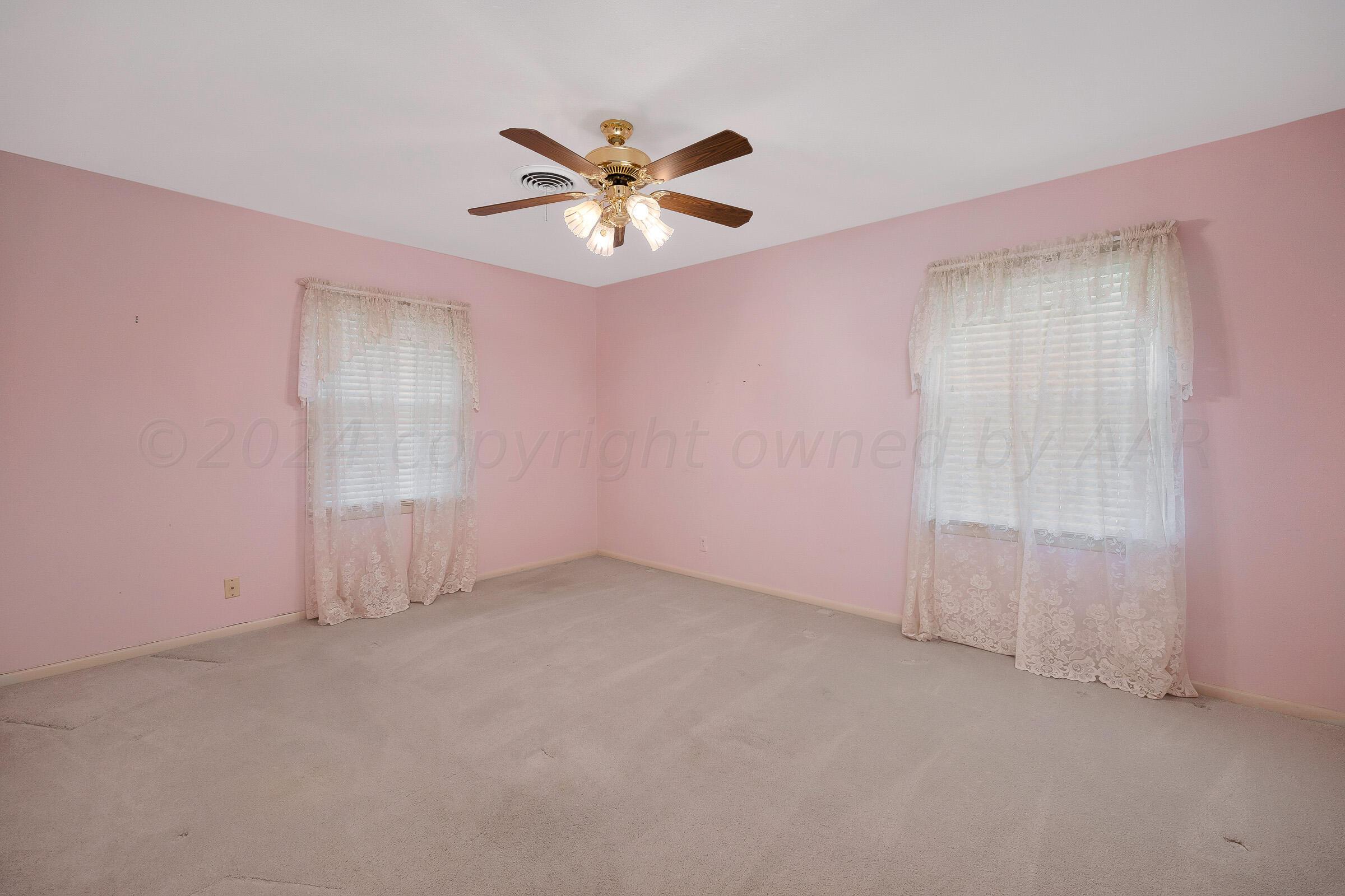5502 Brinkman Drive Amarillo, TX 79106 - Photo 15 of 22 an empty room with windows and fan